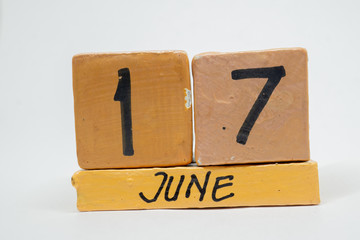 june 17th. Day 17 of month, handmade wood calendar isolated on white background. summer month, day of the year concept