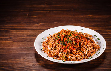 Roasted meat, groats and vegetables