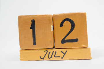 july 12th. Day 12 of month, handmade wood calendar isolated on white background. summer month, day of the year concept