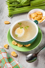 Chicken broth with sliced egg and crackers