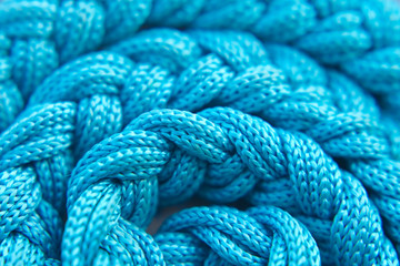 Background with many light blue braided ropes. Soft focus.