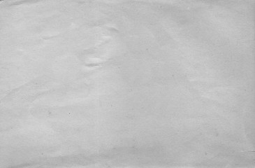 A sheet of plain white paper with a crumpled surface