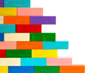 Wall from colorful wooden blocks isolated on white background