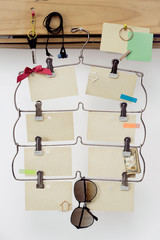Empty sheets for notes on a hanger with different little things around