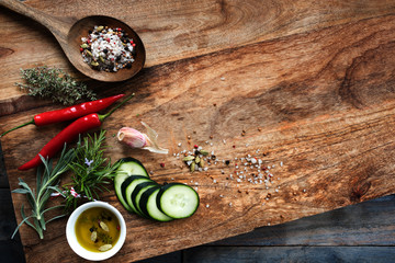 Spices and fresh cucumber on chopping board