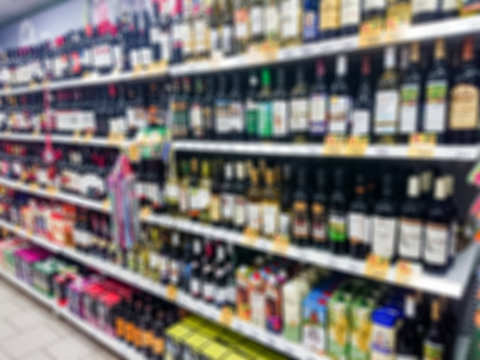 Blurred abstract image. Goods on the shelf of a grocery store. Wine and other alcoholic beverages.