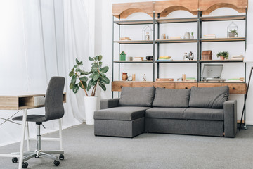 modern living room with sofa, racks and workspace