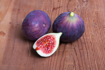 Fresh fruits, figs on the wooden background.