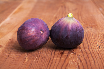 Fresh fruits, figs on the wooden background.