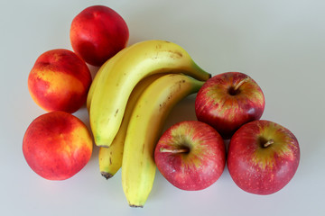 fresh peaches, bananas and apples isolated on white 