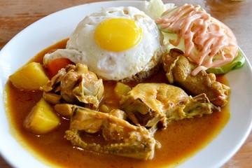 Chicken curry with rice and egg on a plate