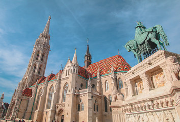 Budapest Mathias Church and St. Stephen's statue with blue sky