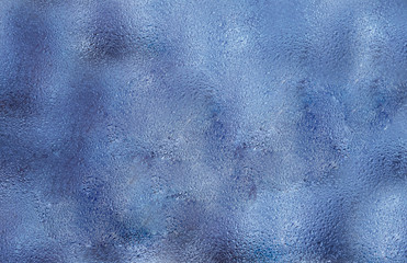 wet glass in drops of rain. wet background of blue.the texture of the wet glass