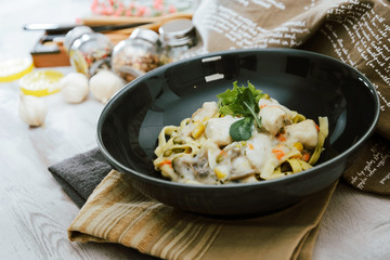 close-up of plate of pasta and chicken with lettuce