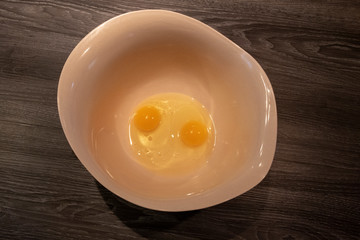 two raw eggs in large mixing bowl