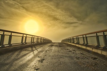 Fototapeta na wymiar Nebellandschaft mit Brücke und Sonne