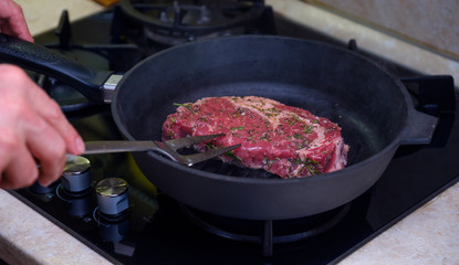 Beef steak with a sprig of rosemary on a plate. Image.