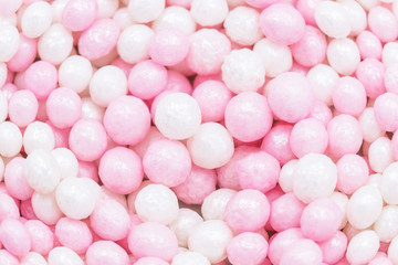 Pink and white sweet sugar balls. Sweet pastel background. Sprinkles sugar texture. Balls pattern