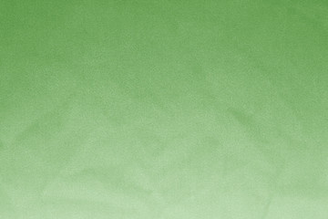 Elegant green textile background. Silk cloth texture. Fabric pattern.