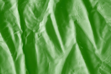 Elegant green textile background. Silk cloth texture. Fabric pattern.