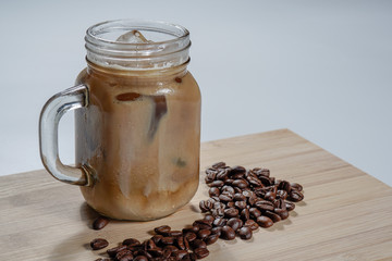 Coffee with milk or latte and coffee beans