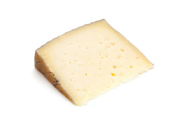 Spanish Manchego cheese produced in the La Mancha region of Spain, isolated on a white studio background.