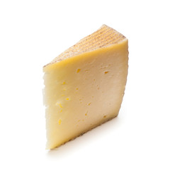 Spanish Manchego cheese produced in the La Mancha region of Spain, isolated on a white studio background.