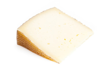Spanish Manchego cheese produced in the La Mancha region of Spain, isolated on a white studio background.