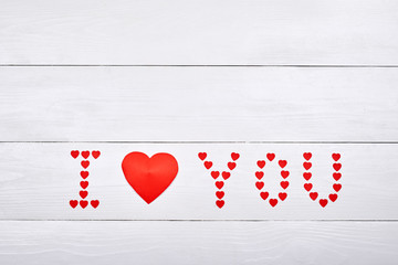 Sign I Love You made from red paper hearts on white wooden background, copy space. Saint Valentines Day. Love concept, Top view, flat lay