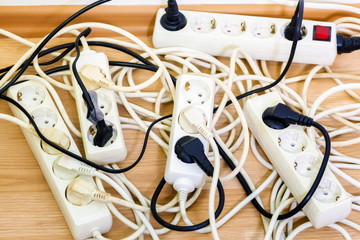 Old and unsafe overloaded power strips - obrazy, fototapety, plakaty