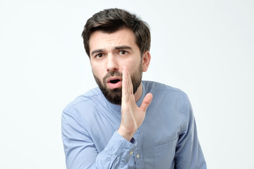 Man whispering gossip isolated on a white background
