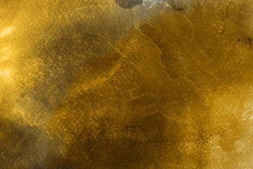 Gold luxury ink and watercolor textures on white paper background. Paint leaks and ombre effects. Hand painted vintage texture.