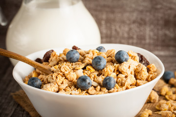 Healthy breakfast concept with oat flakes and fresh berries on rustic background. Food made of granola and muesli. Healthy banana smoothie with blackberries, honey and milk.
