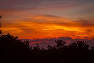 Fototapeta na wymiar Autumn evening skies, Beautiful orange sun set over the peaceful Mountains in the Mediterranean, Cyprus