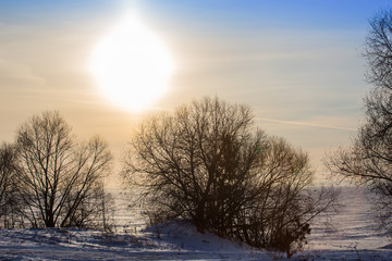 sunset over the winter ice surface of the lake