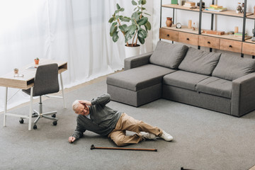 old man falled down on floor of the room