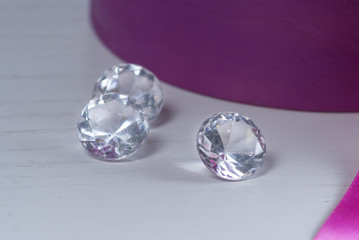decorative diamonds on the table near violet box with flowers