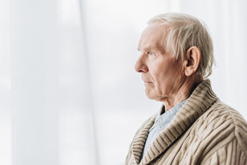 sad senior man with dementia disease at home