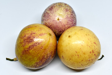 Passion fruit, yellow and purple on a white background