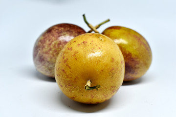 Obraz premium Passion fruit, yellow and purple on a white background