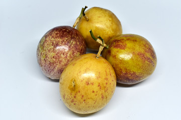 Passion fruit, yellow and purple on a white background