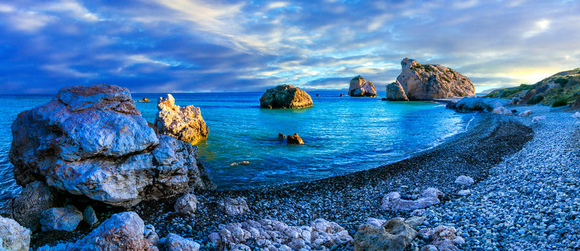 Aphrodite Rock Petra tou Romiou 12k panorama at sunset in Cyprus. Scenic Paphos coastline view of legendary birthplace of Aphrodite and sea stacks. Mediterranean sunset travel scenery