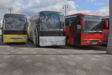 Fototapeta na wymiar buses on parking on the background of cloudy sky