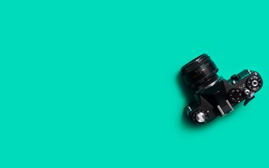 top view of vintage 35mm film camera on green background 