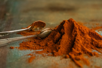 pile of red paprika and cutlery on an old table, copy space