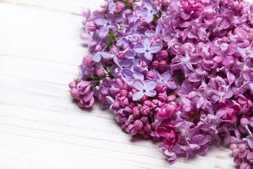 Obraz na płótnie Canvas Lilac flowers on white wooden background, copy space,