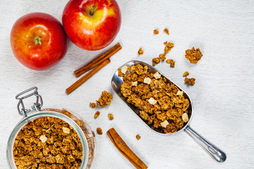 Scoop Full of Organic Apple Cinnamon Granola. Selective focus.
