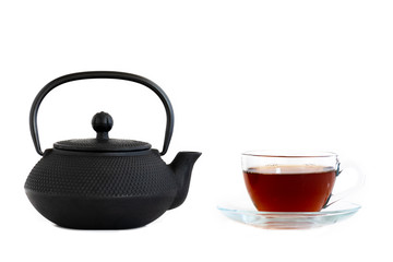 black cast iron teapot, Cup of tea, isolated on white background