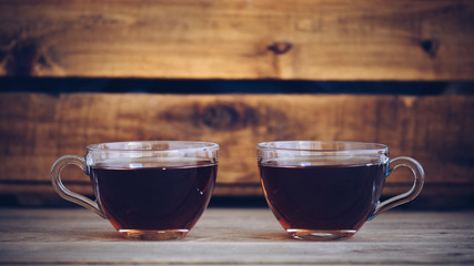 two cups of you faced in a still life, vintage style