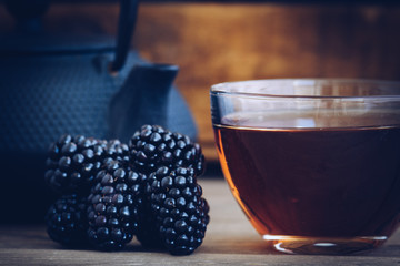 cups of you and iron Kettle, a few blackberries in vintage style